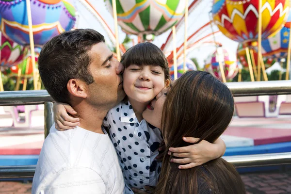 Happy parents kissing daughter — Stock Photo, Image