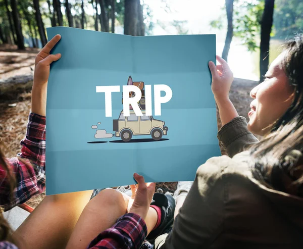 Girls holding paper sheet in forest — Stock Photo, Image