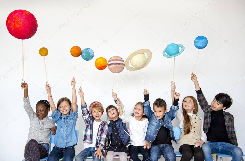 children holding solar system