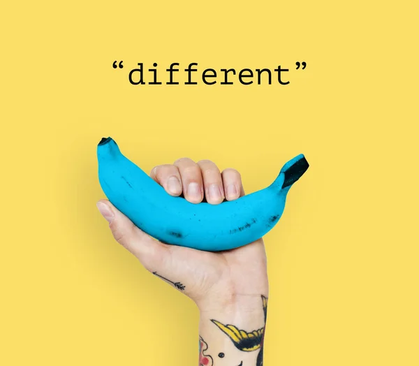 Tattooed person holding banana. — Stock Photo, Image