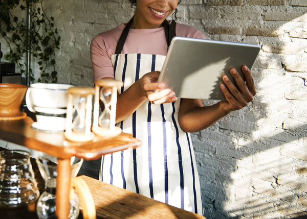 African woman in apron working in shop 