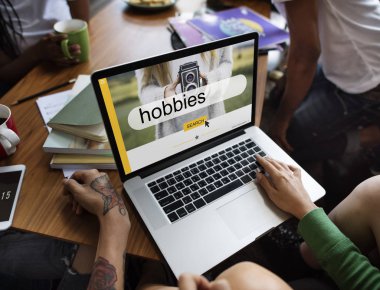 Arkadaşlar masada dizüstü bilgisayar kullanarak