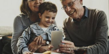 grandparents and grandson using smartphone clipart