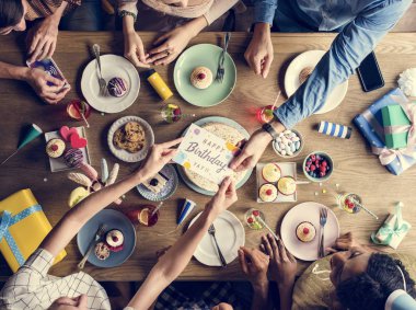 İnsanlar masada doğum günü kutlamak 