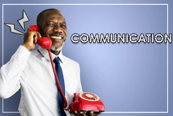 Affärsman med röd telefon — Stockfoto