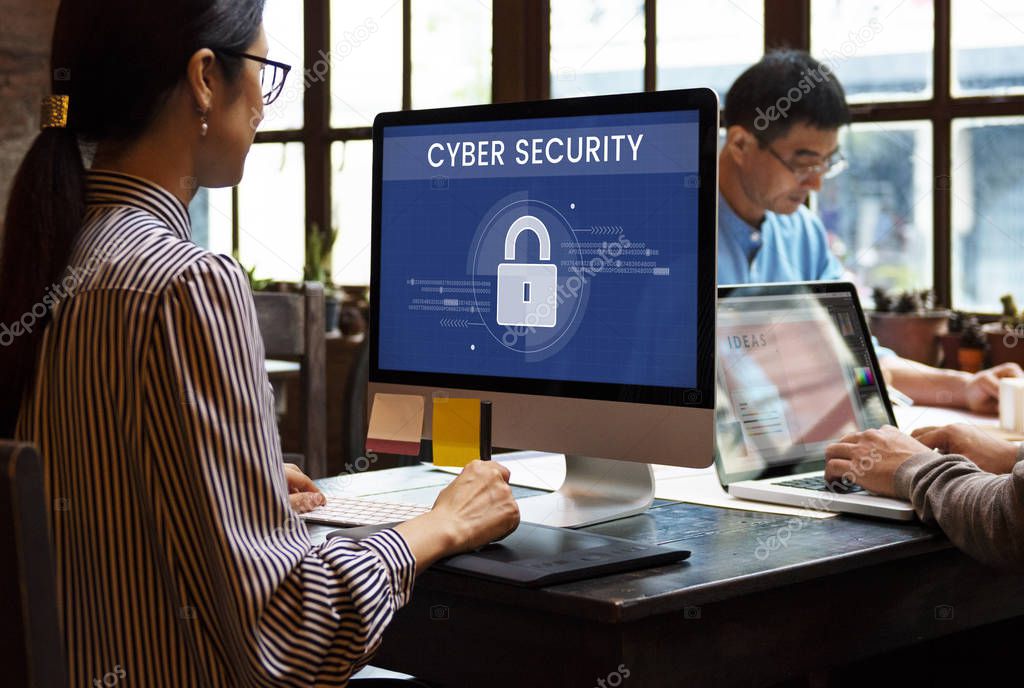 Asian business people working in modern office and using computer and laptop, monitor screen with title: Cyber Security