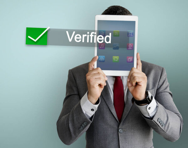 business man covering face with digital tablet 