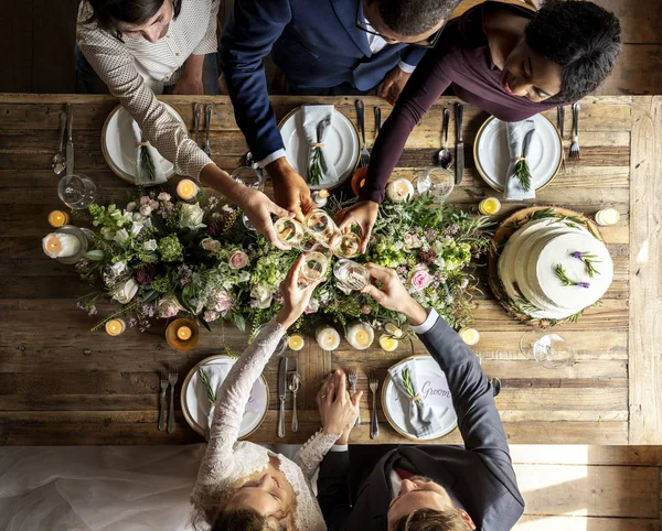 Mensen vieren bruiloft aan tafel — Stockfoto