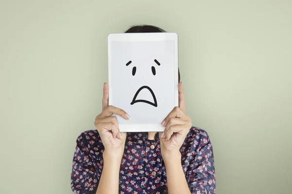 Woman holding digital tablet covering face — Stock Photo, Image