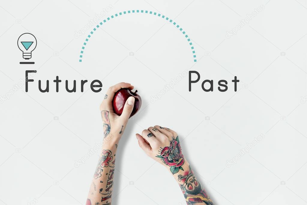 Tattooed person holding apple. 