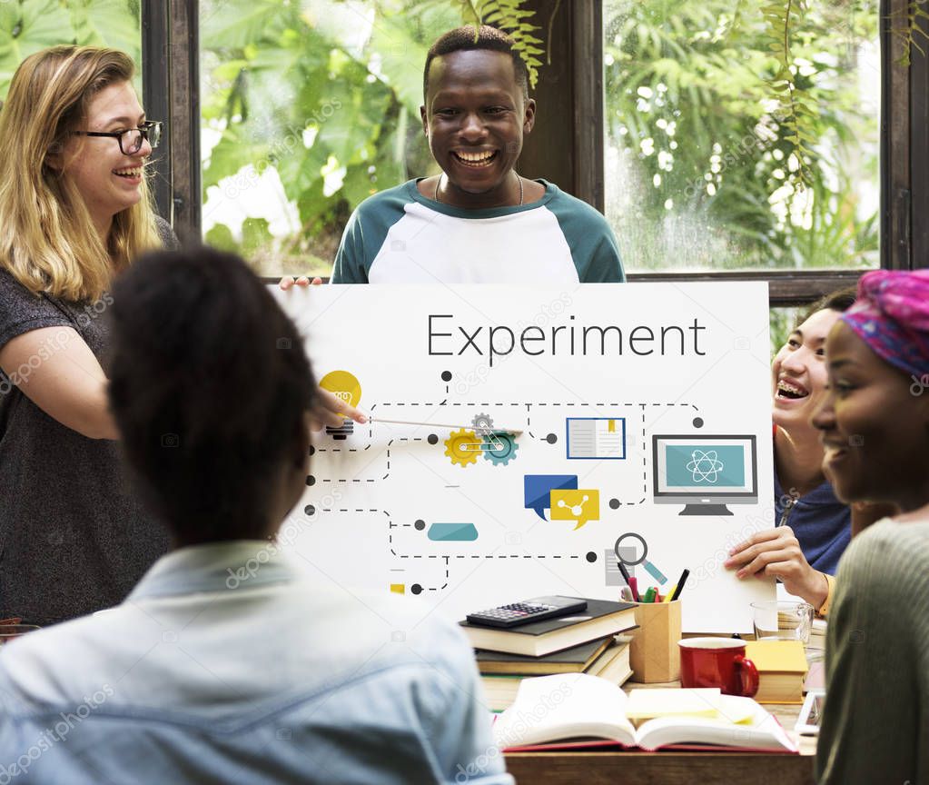 Group of multi-ethnic students learning together, blonde woman holds pointer showing on placard with Experiment Concept