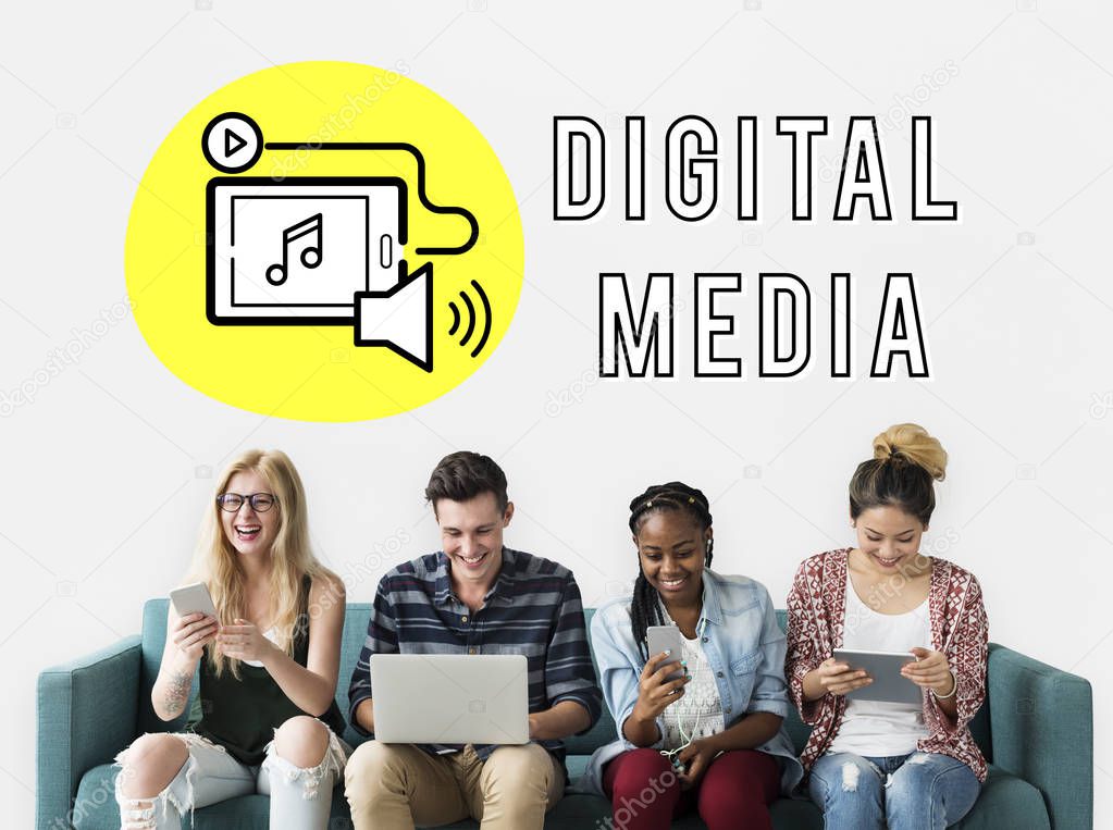 Multi-ethnic group of friends using digital devices and sitting on sofa, background wall with title: Digital Media
