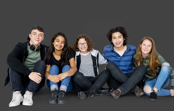Teenagers sitting together on the floor — Stock Photo, Image