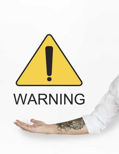 Male hand pointing at warning sign — Stock Photo, Image