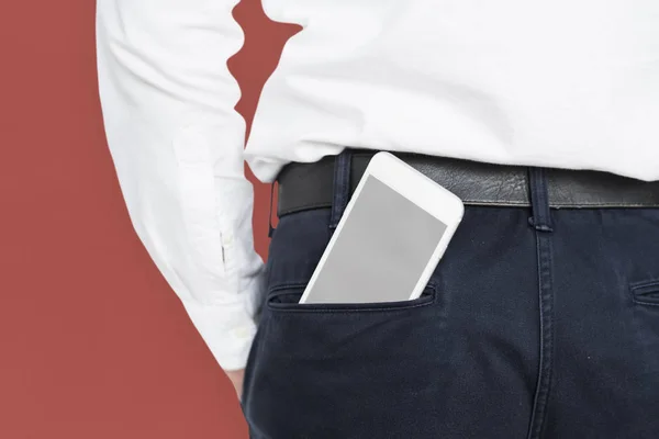 smartphone in pocket of male trousers