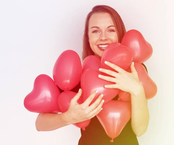 Woman and heart balloons — Stock Photo, Image