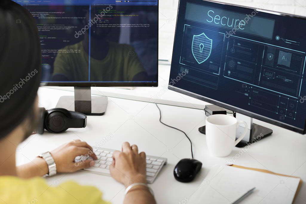 Indian man working with computer monitors, text: Secure