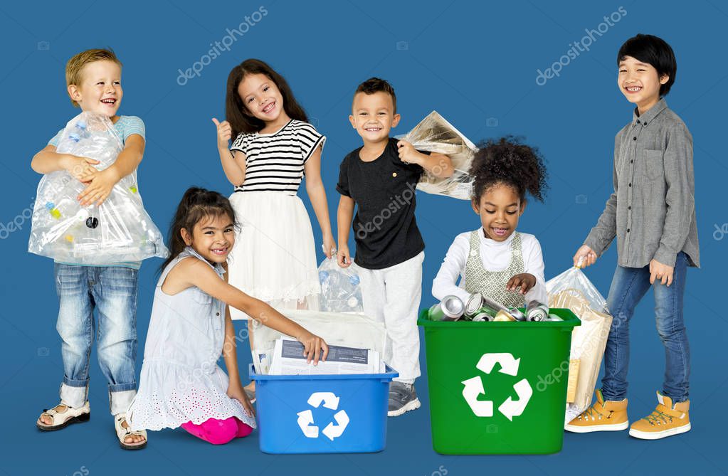 Group of adorable kids with waste for recycling