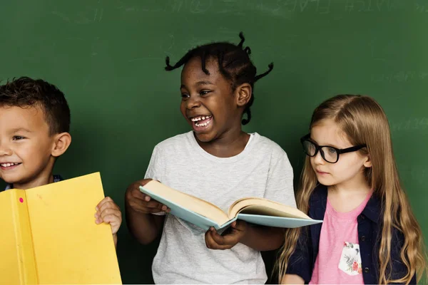 Děti s úsměvem s učebnice — Stock fotografie
