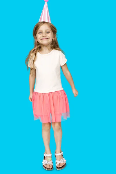 Girl jumping in birthday hat — Stock Photo, Image