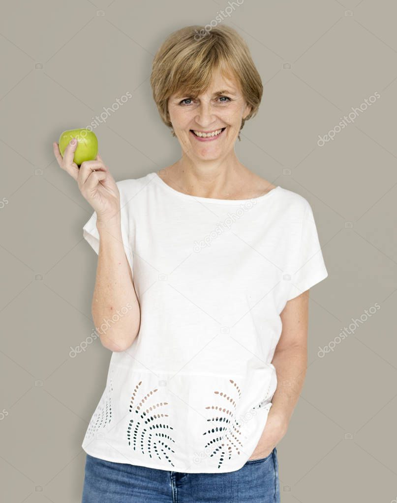 mature woman holding apple