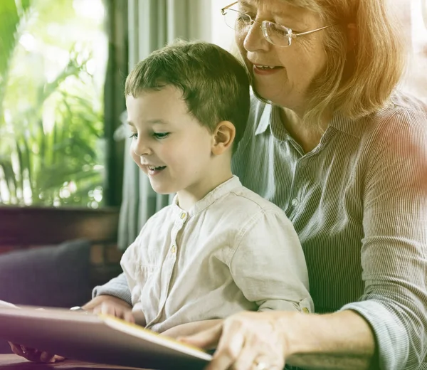 Grandmother and grandson reading book — Stock Photo, Image