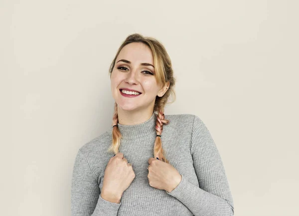 Sonriente mujer sosteniendo trenzas — Foto de Stock