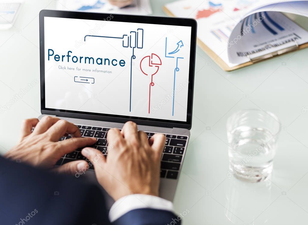 Business man working with laptop at office workplace table, text on monitor screen: Performance