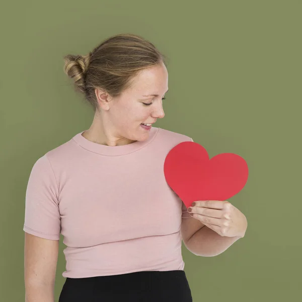 Woman looking at red paper heart — Stock Photo, Image