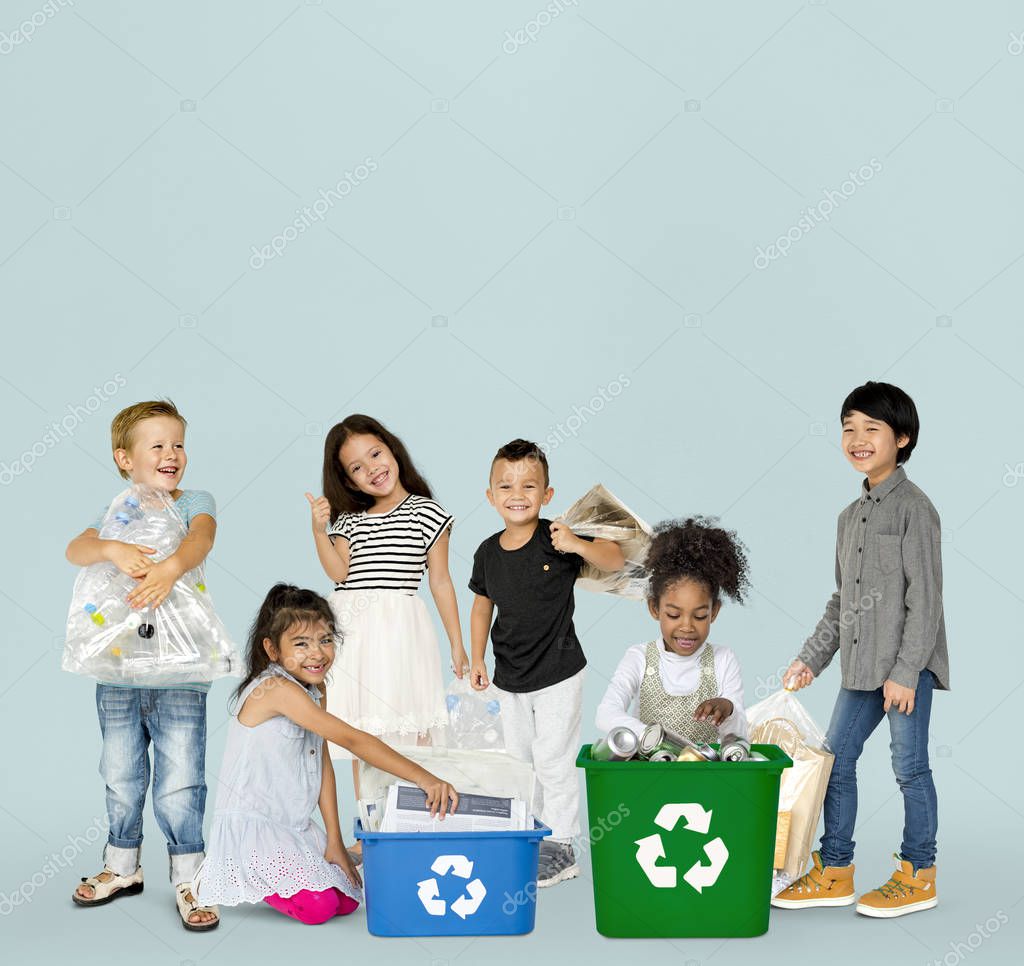 Group of adorable kids with waste for recycling