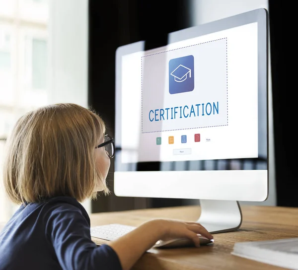 Little girl looking at monitor screen — Stock Photo, Image