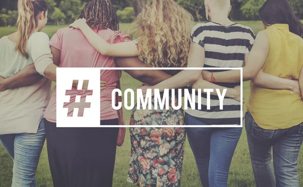 Five women embracing in front of park — Stock Photo, Image