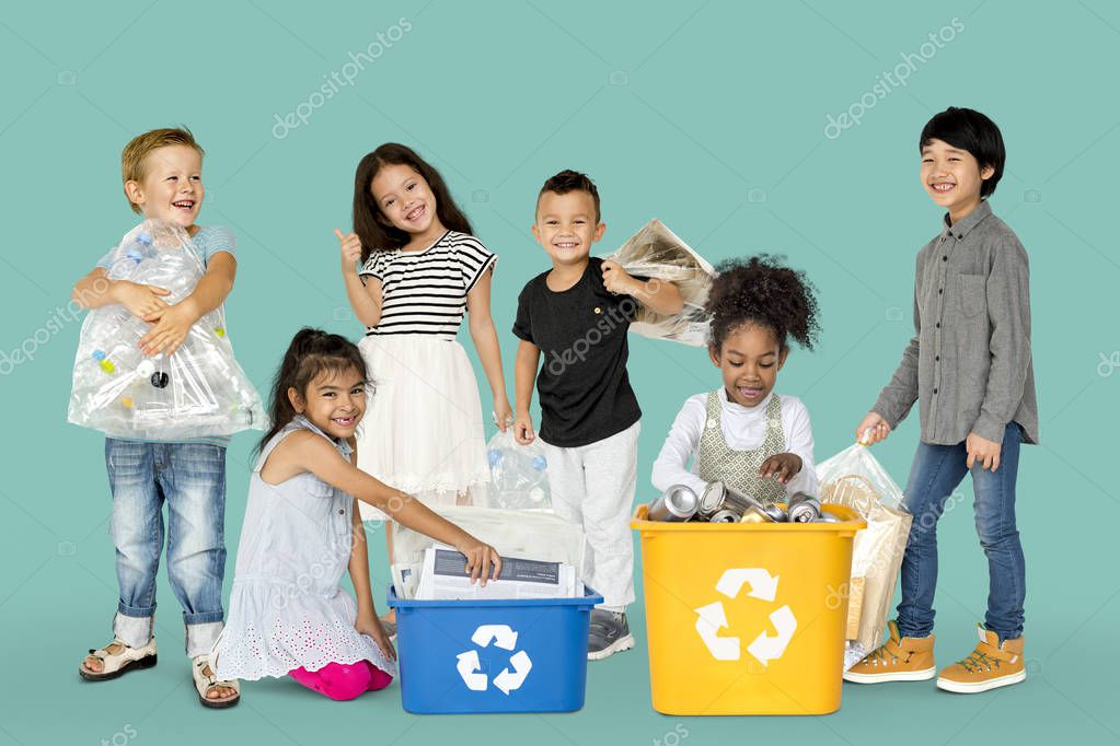 Group of adorable kids with waste for recycling