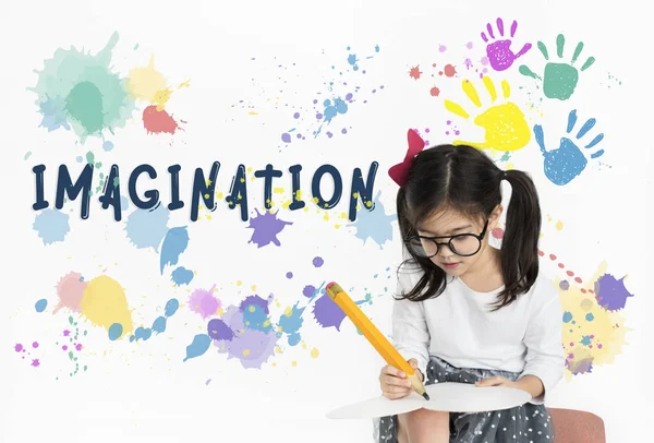 Cute little girl writing with big pencil — Stock Photo, Image