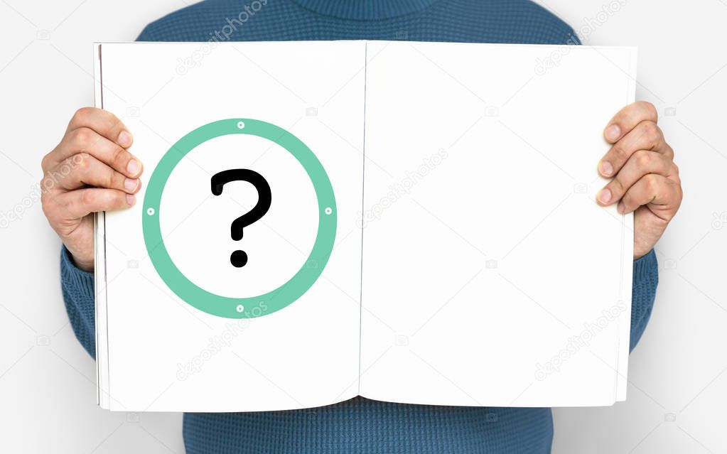 Cropped shot of man holding open book with question mark
