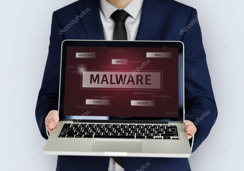 Man holding laptop with network graphic overlay and text Malware