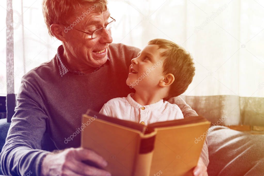 grandfather and grandson reading book