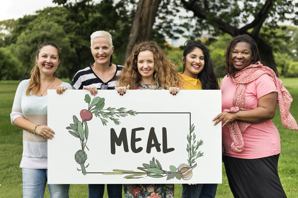 five smiling women holding banner 