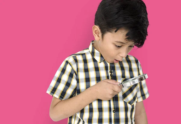 Boy looking in magnifying glass — Stock Photo, Image