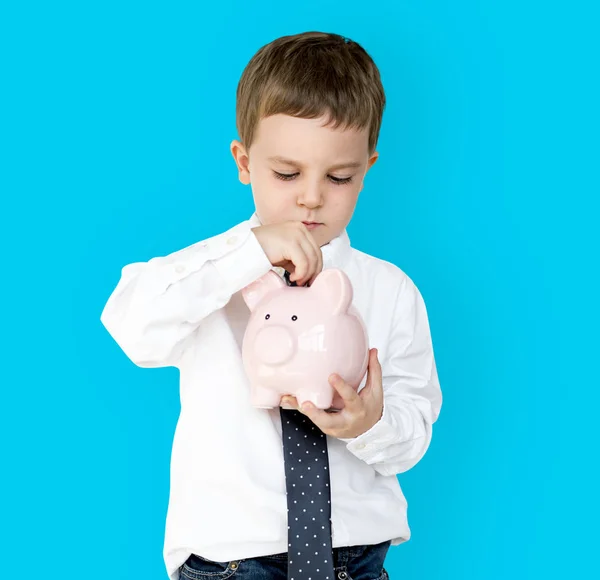 Chico holding piggybank —  Fotos de Stock