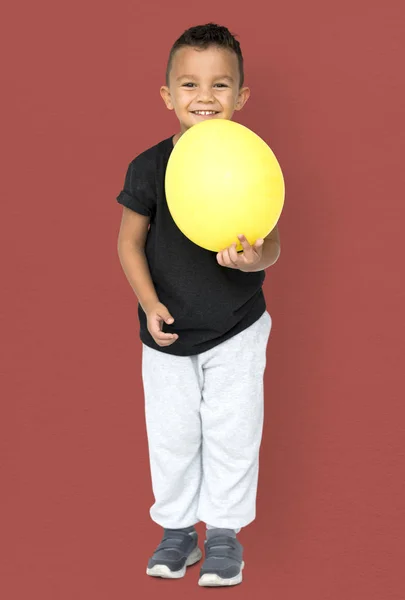 Boy with yellow balloon — Stock Photo, Image