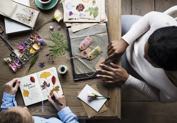 Women creating labels with pressed flowers — Stock Photo, Image