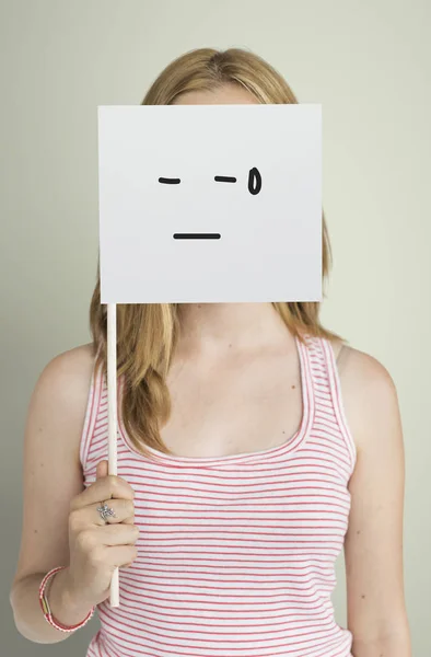 Woman covering face with paper flag — Stock Photo, Image