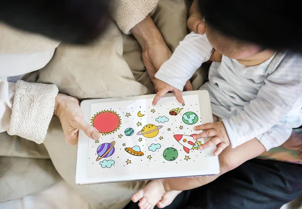 Parents giving tablet to little baby — Stock Photo, Image