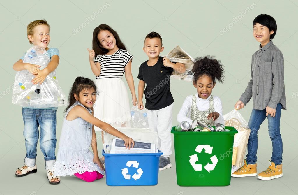 Group of adorable kids with waste for recycling