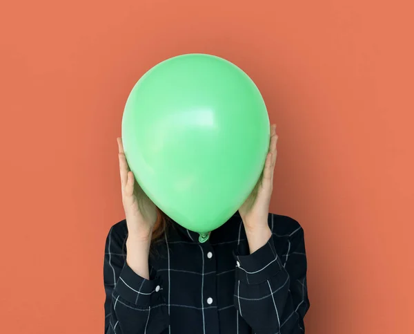 person holding green balloon
