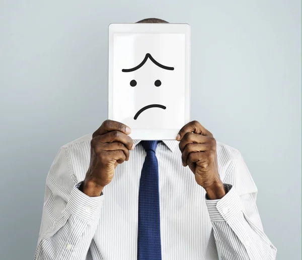 Businessman covering face with digital tablet — Stock Photo, Image