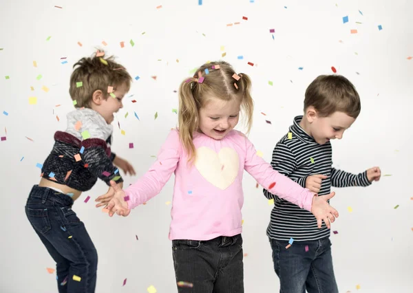 Happy children with confetti — Stock Photo, Image