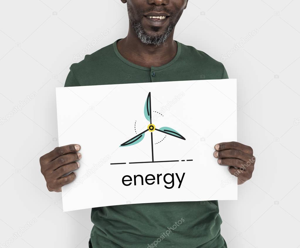Smiling african american man holding placard in the studio, Energy Concept
