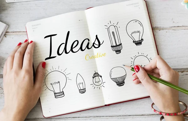 Person drawing light bulbs — Stock Photo, Image